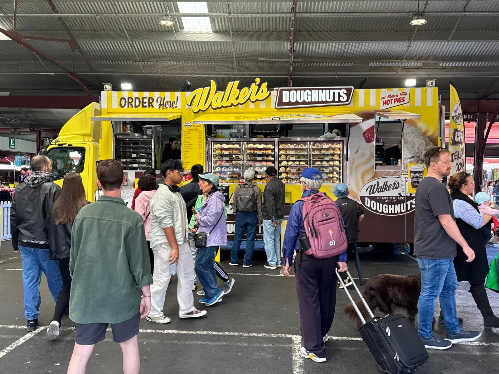 Walker's Doughnuts truck serving a large public event crowd