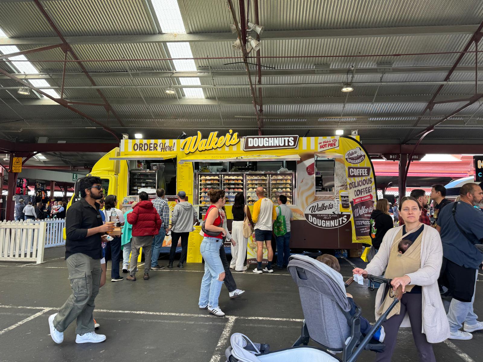 Walker's Doughnuts food truck serving crowds at a public event